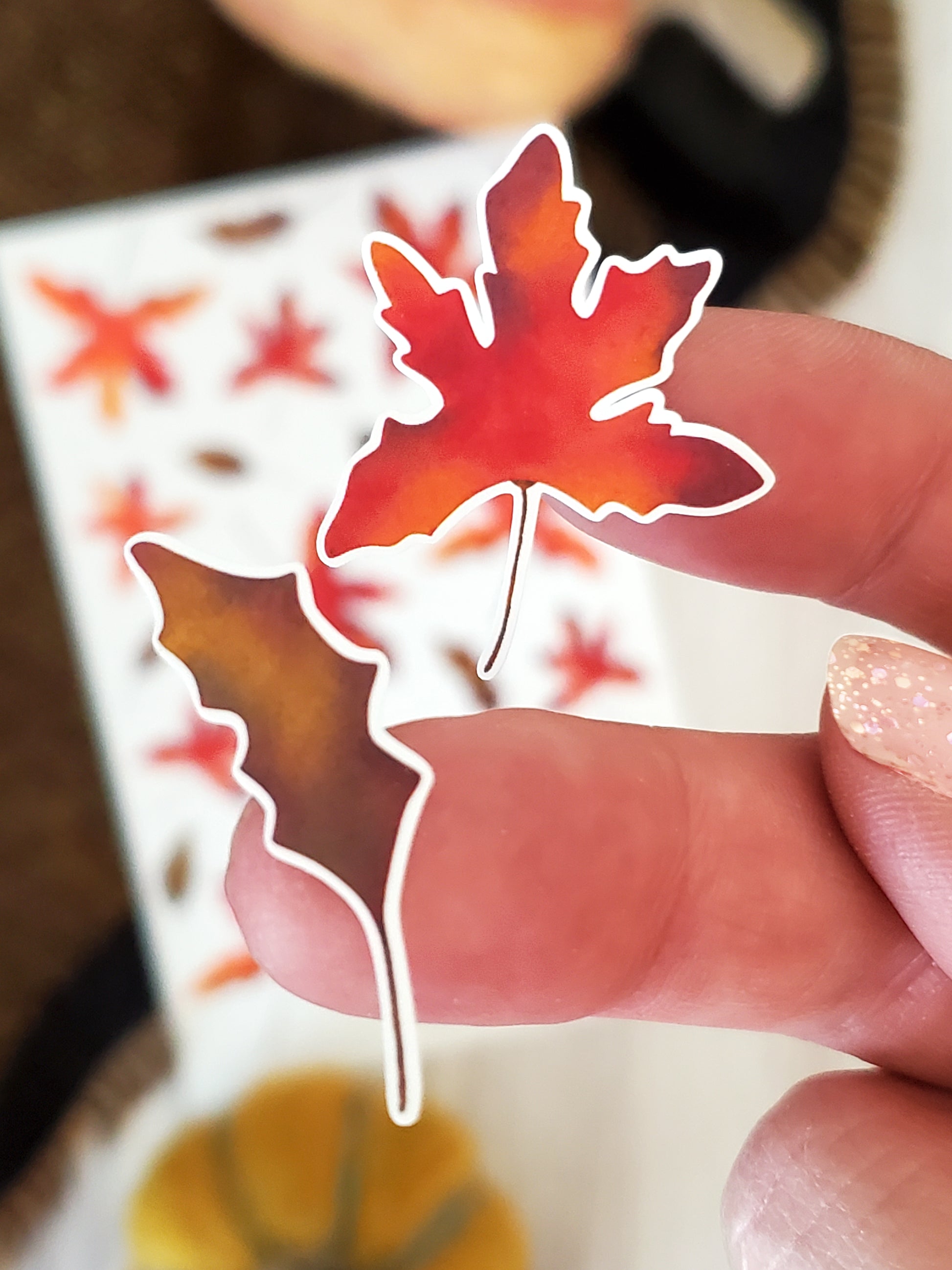 close up of two fall leaf stickers