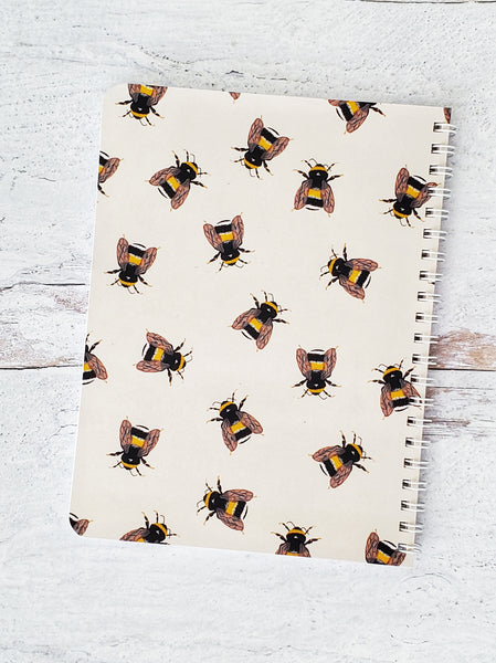 back cover of notebook with illustrated bees pattern on beige background