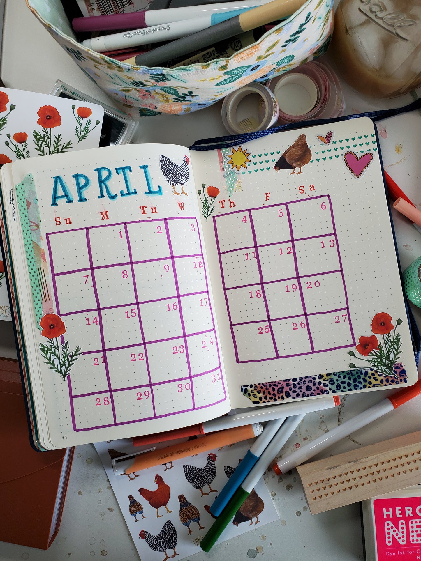 An bullet journal monthly spread decorated with the chicken stickers. 