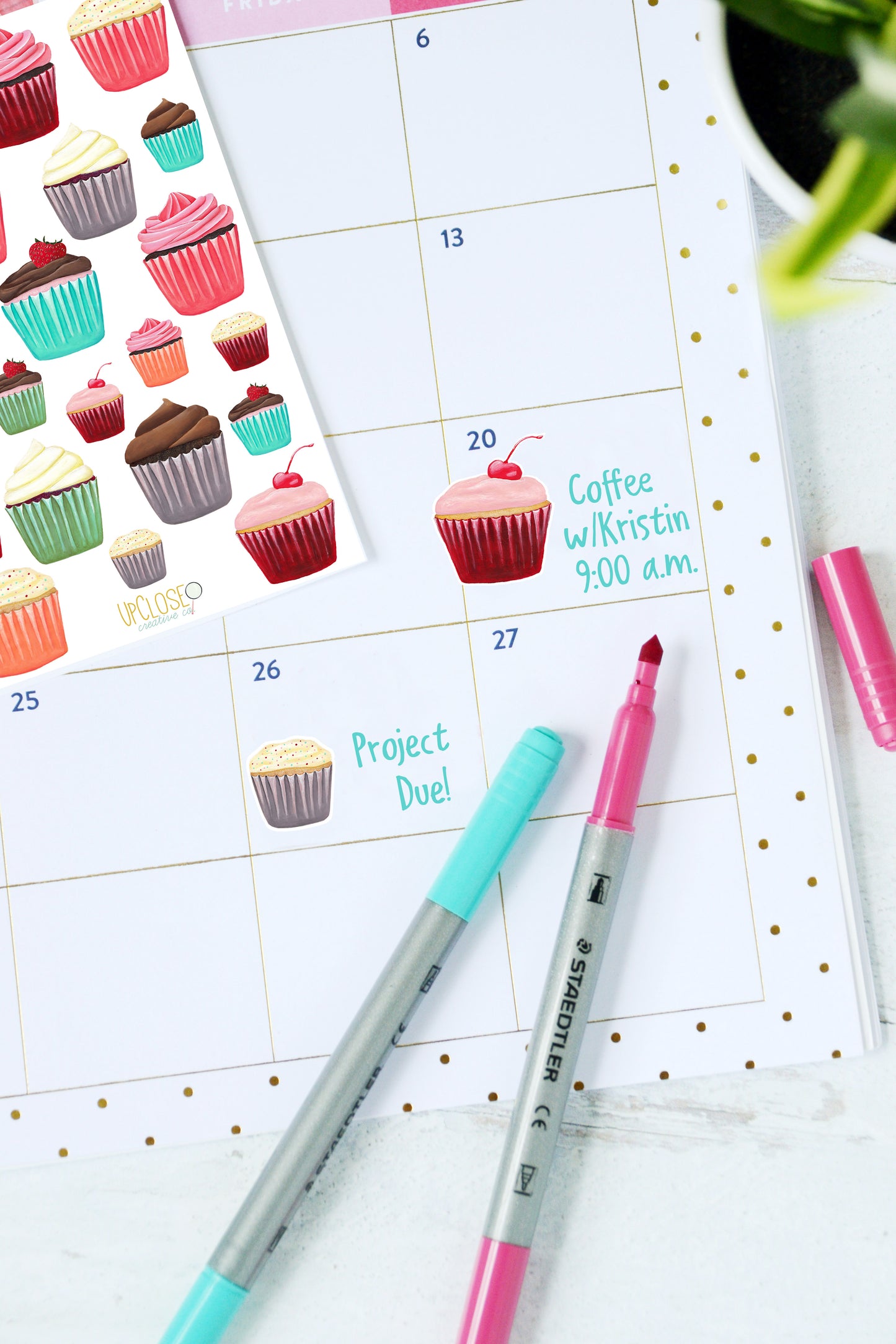 A planner page decorated with a pink cherry cupcake and sprinkle cupcake