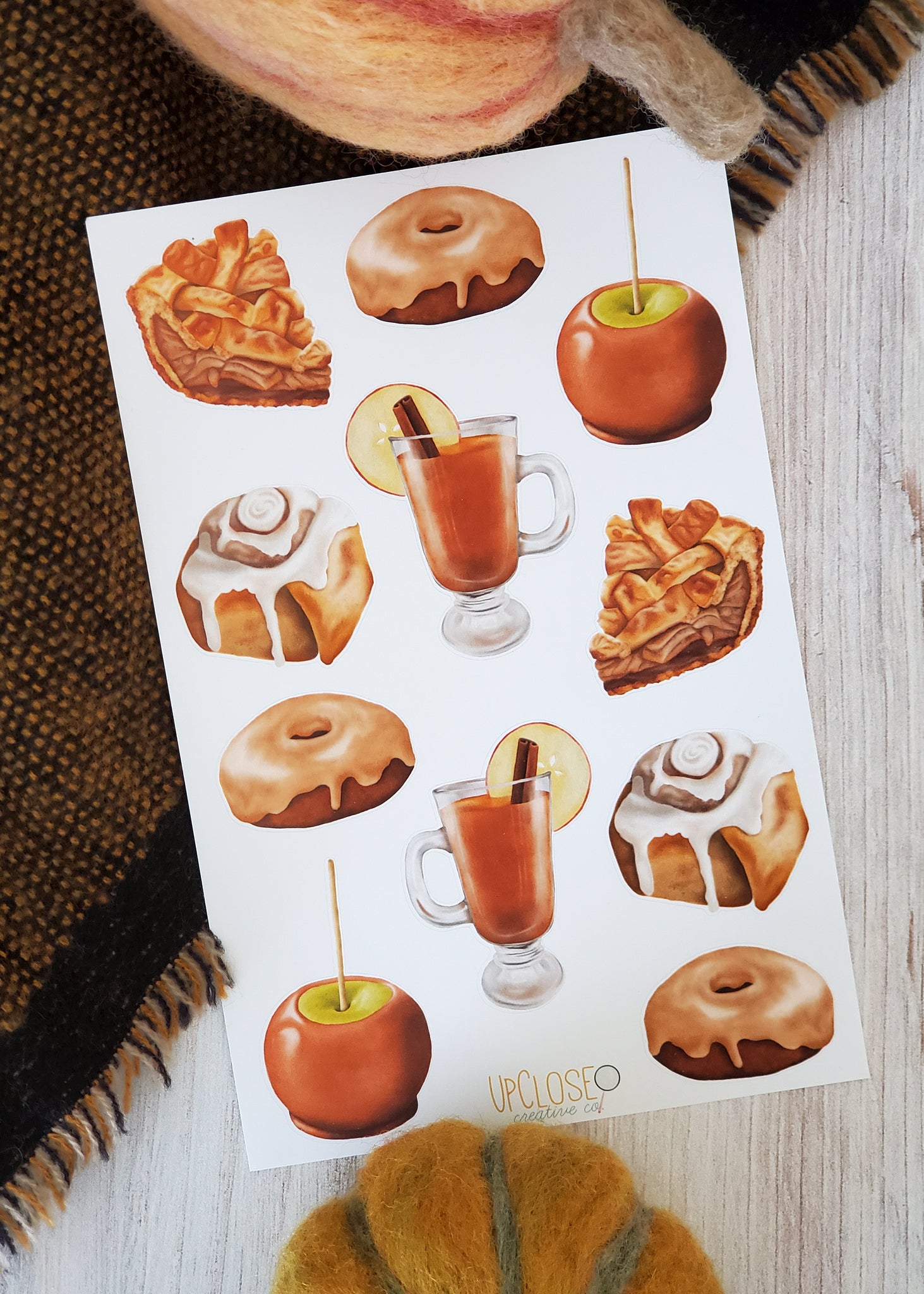 sticker sheet featuring illustrated fall desserts apple pie caramel apple cinnamon roll donut apple cider
