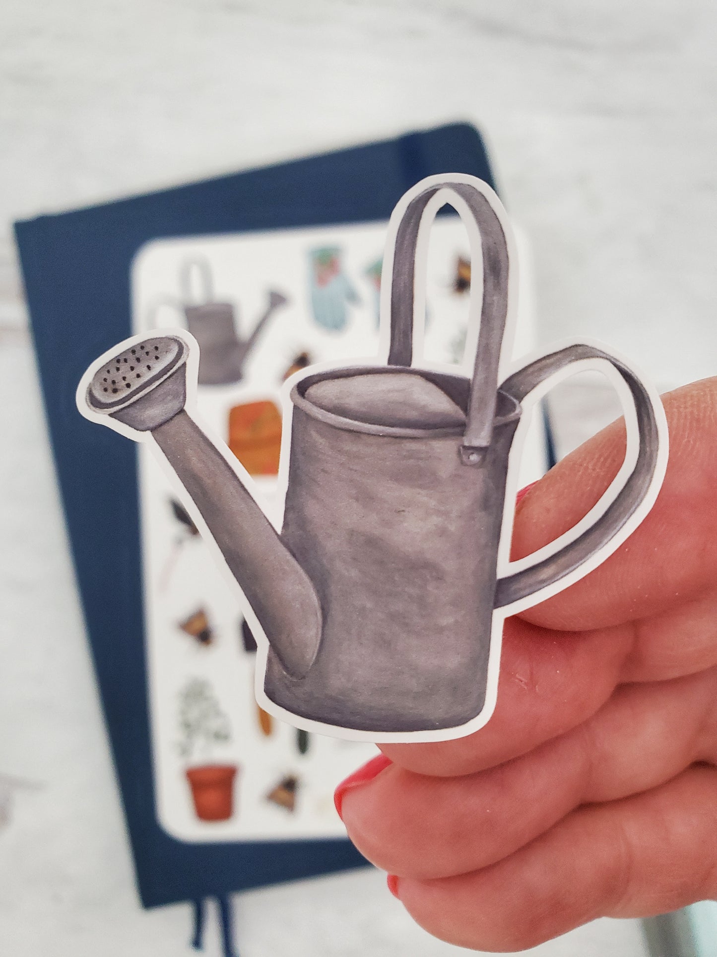 A close up of the watering can sticker. The can is the galvanized metal kind.