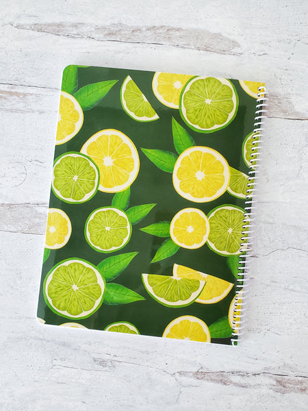 back cover of spiral notebook with illustrated lemon and lime slice pattern on dark green background