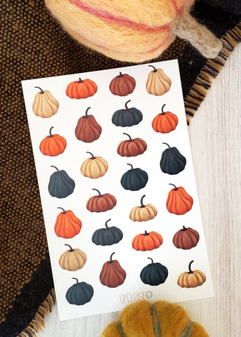 sticker sheet with illustrated pumpkins of various shapes and sizes in the colors orange, deep blue, mauve and cream