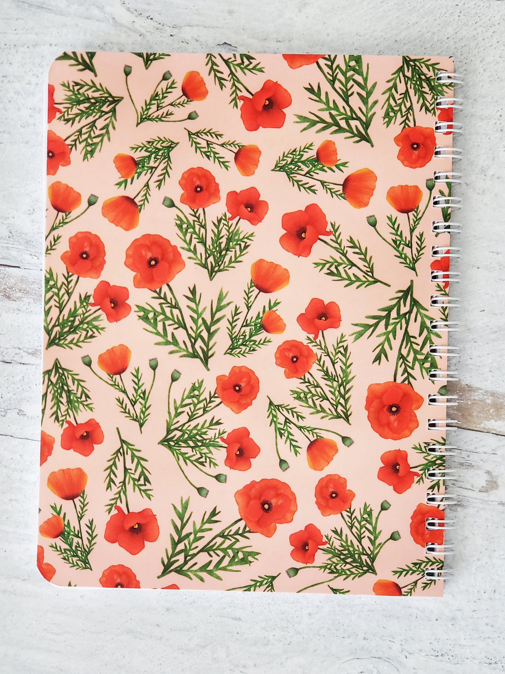 back cover of notebook with illustrated poppy pattern on light pink background
