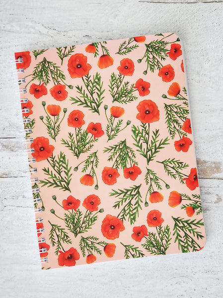wire bound notebook with illustrated red poppies pattern on pink background