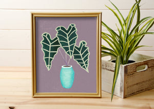 print of hand painted alocasia plant with purple background in gold frame