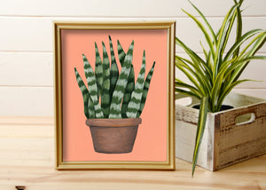 print of hand painted snake plant on orange background in gold frame
