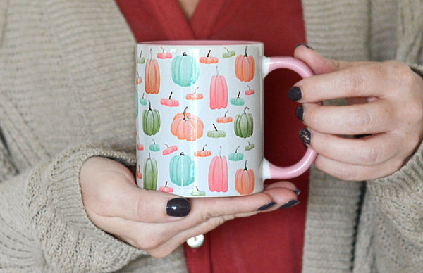 hands holding pumpkin mug
