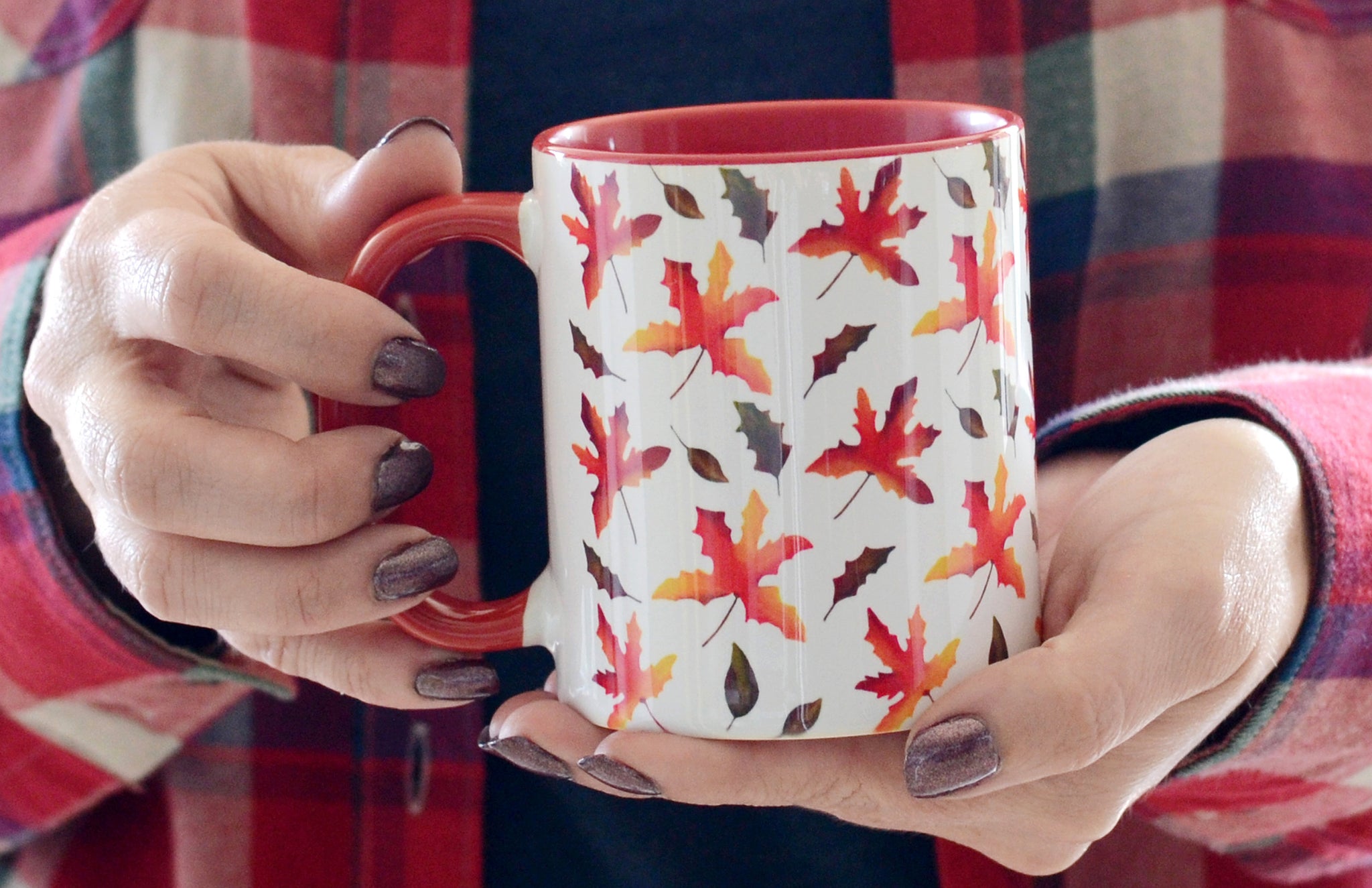ceramic mug with red handle and interior pattern is hand painted fall leaves  illustrations on white background