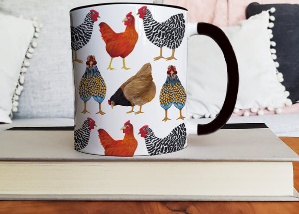 black handled chicken mug sitting on stack of books with a comfy sofa in the background